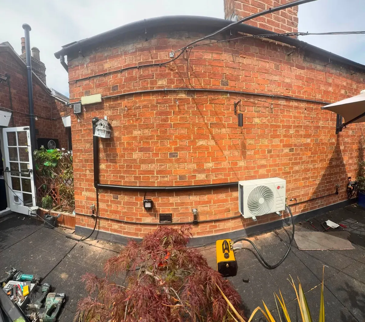 Air con outdoor unit installed by J Lamb, serving Corby